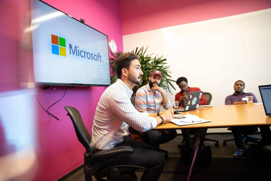 A Rollins grad leads a small group meeting at Microsoft.