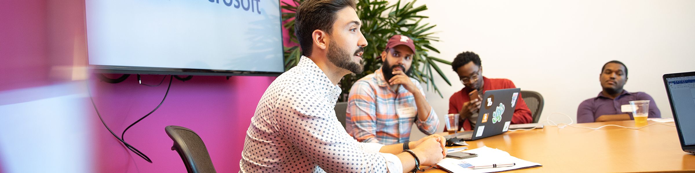 group of males sitting in Microsoft board room table