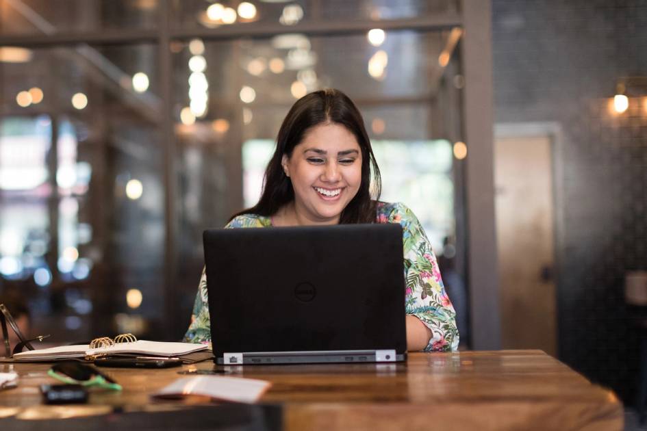 A woman video chats in a coffee shop.