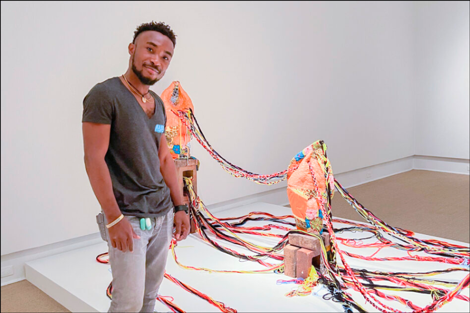 A student displays their art at the Rollins Museum of Art.