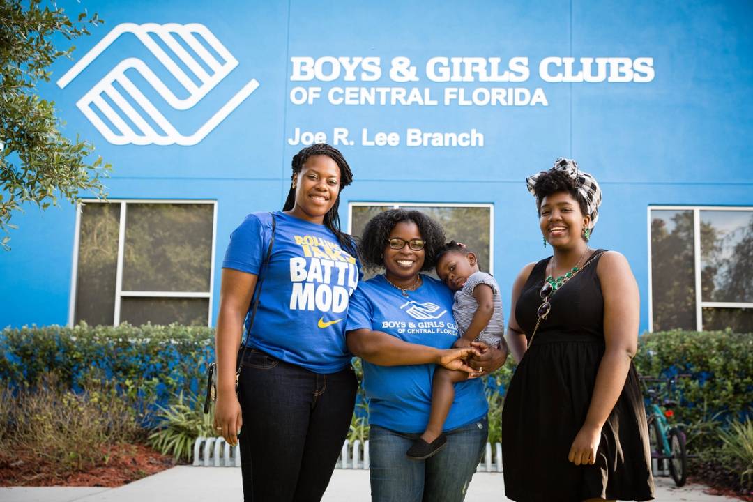 Three students pose in front of Boys & Girls Club of Central Florida.