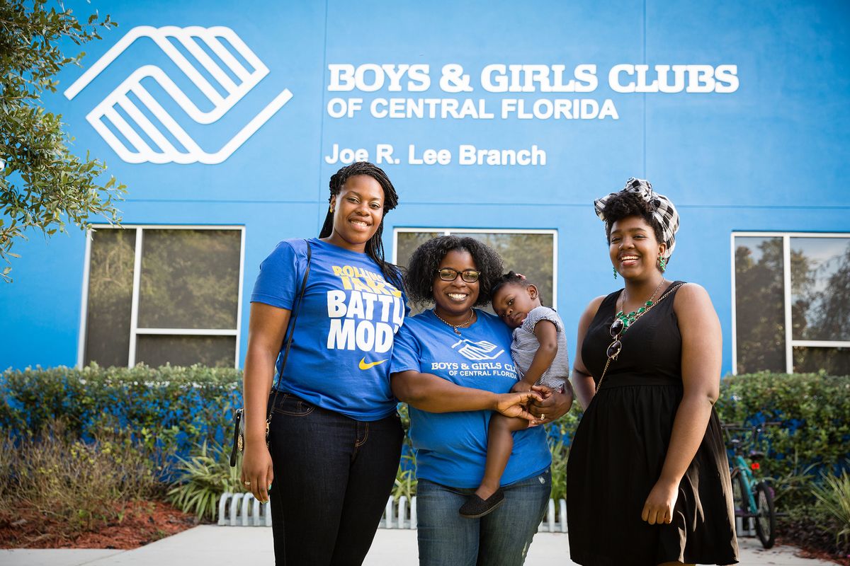 Three students pose in front of Boys & Girls Club of Central Florida.