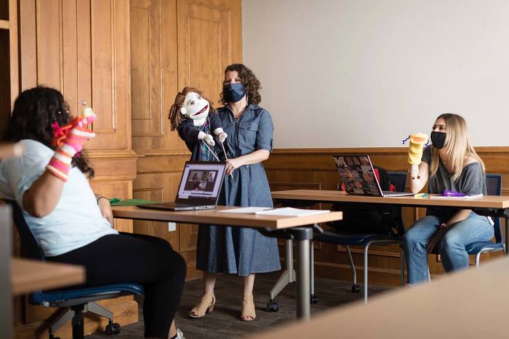 Communication professor Sarah Parsloe and her students use a puppet to communicate with grieving children via Zoom.
