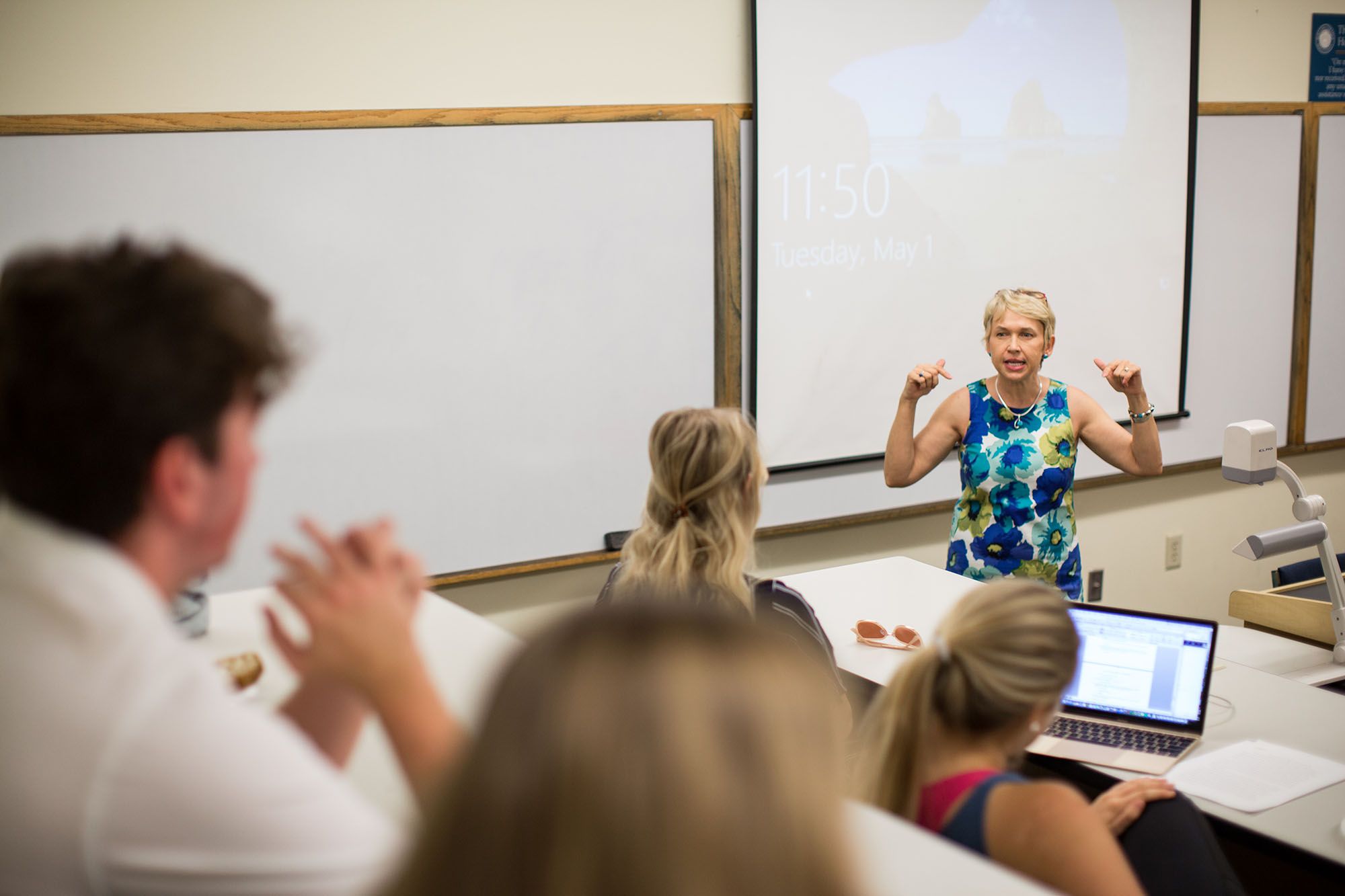 Economics professor Anca Voicu discusses European economies with students.