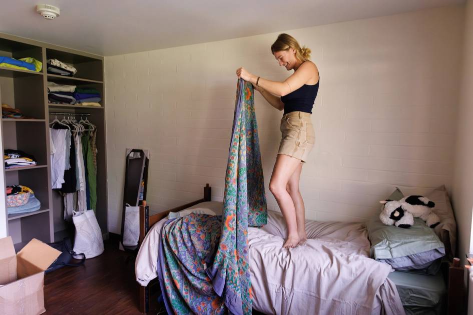 A first-year Rollins College student decorates her room.