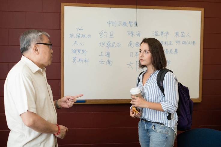 A professor and student talk after class.