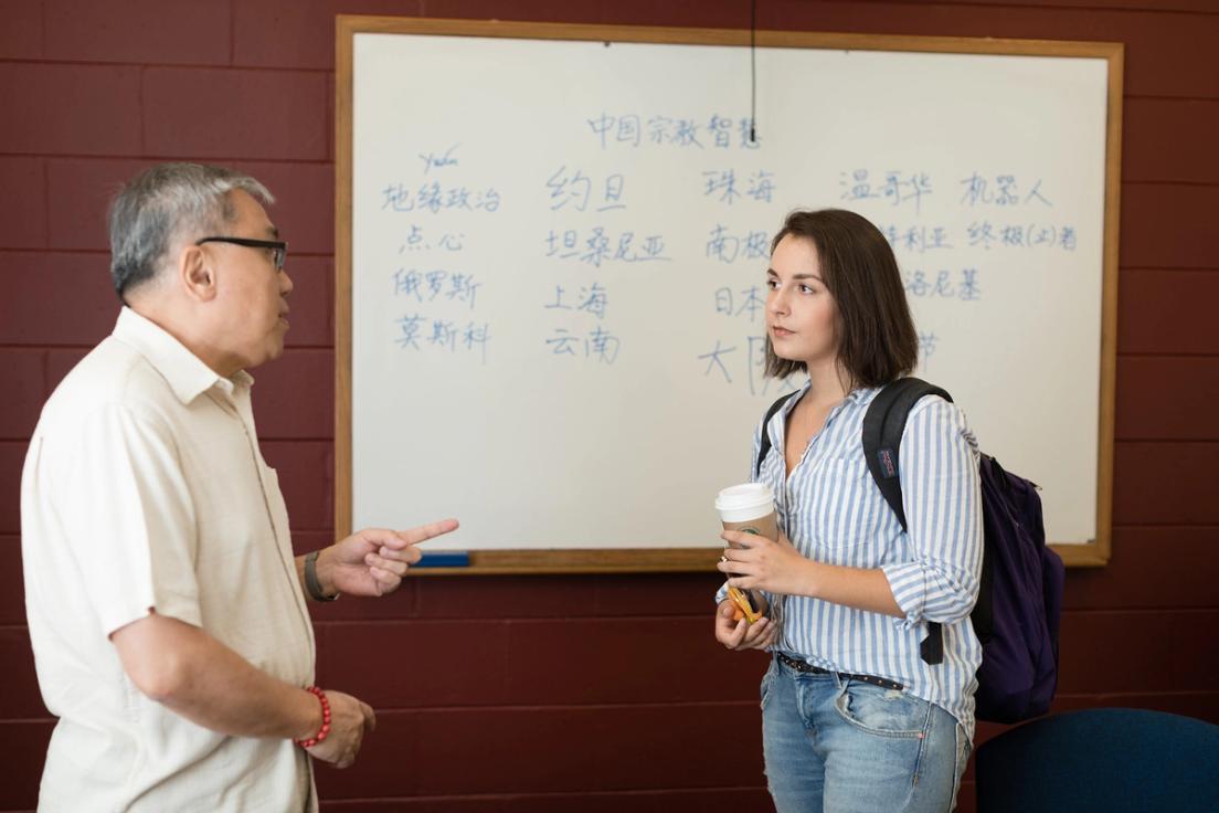 A professor and student talk after class.