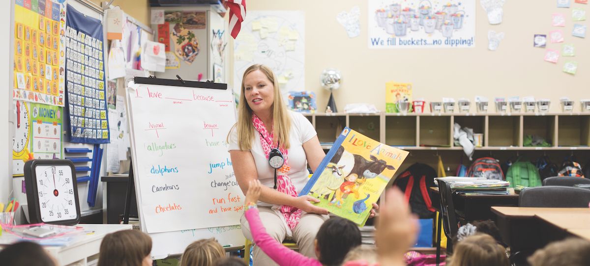A teacher reads to elementary school students.
