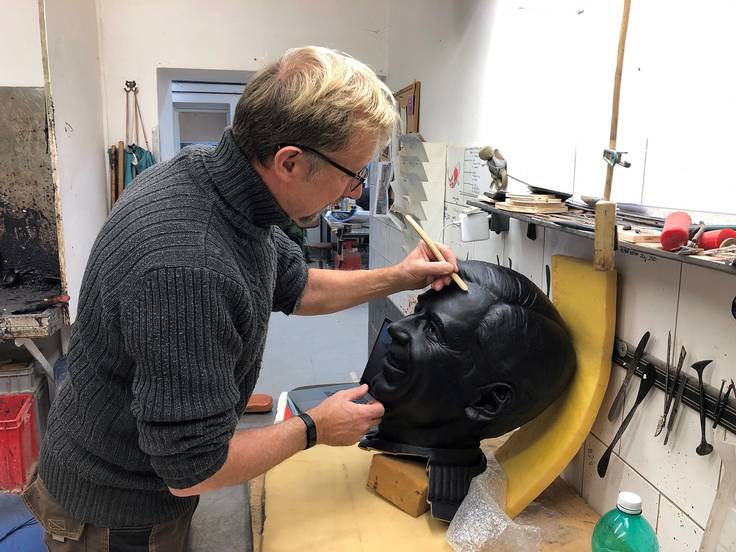 Artist Paul Day working on the head portion of the sculpture of Fred Rogers.