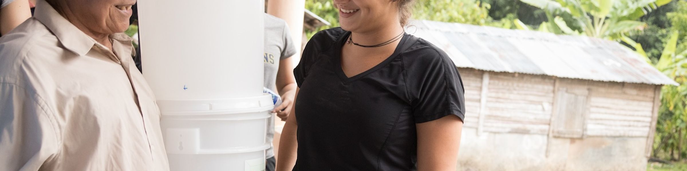 A Rollins college student talks with a resident in the Dominican Republic.