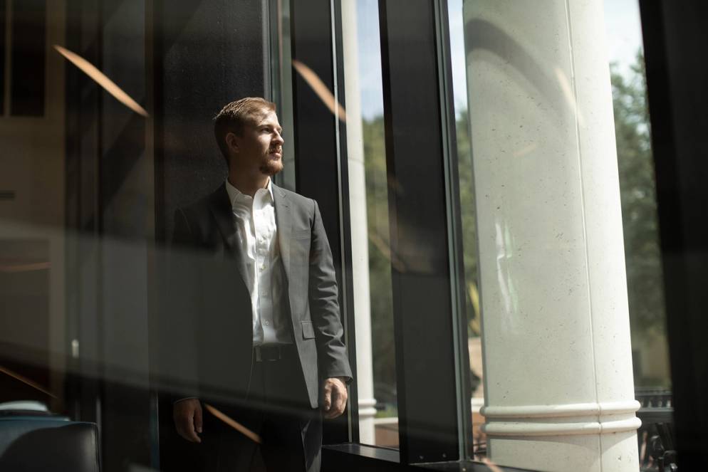 Caleb Archuleta gazes out a window in the Bush Science Center. 