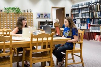 A student and a professor conduct research focused on women‘s studies.