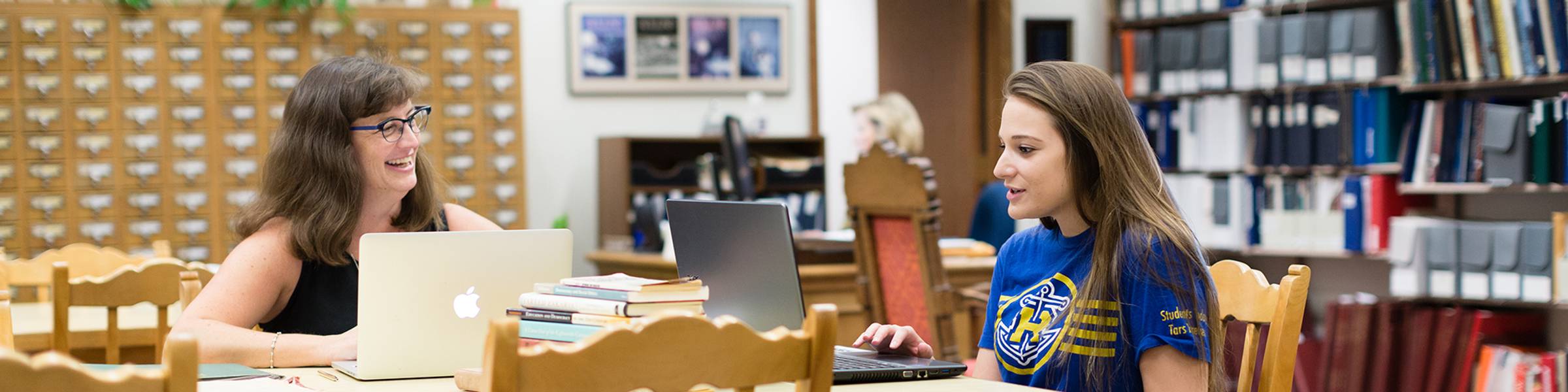 A student and a professor conduct research focused on women‘s studies.