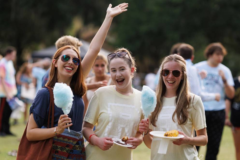 Students enjoying barbecue and cotton candy to cap off Fox Day 2022.