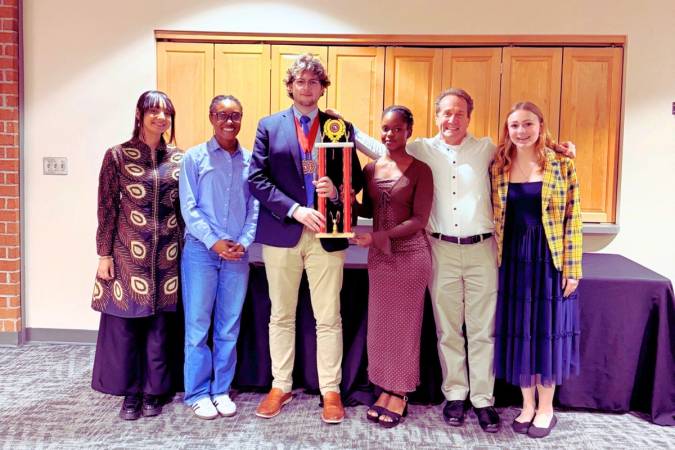 The Rollins College Debate Team with their trophy the 2026 Florida Intercollegiate Forensics Association State Tournament 