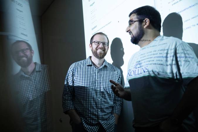 Dan Myers with a student during a presentation.