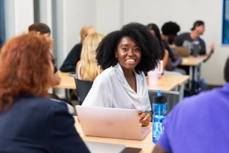 Student in Holt class smiling at camera
