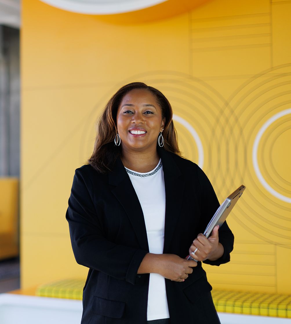 Tiffany Jones poses for a portrait in front of the Google logo in the company’s Atlanta office.