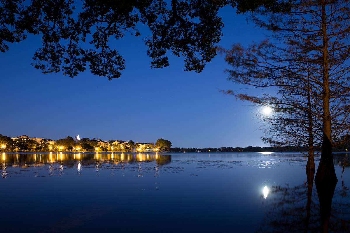 Rollins College campus nighttime view under the moonlight on Lake Virginia.
