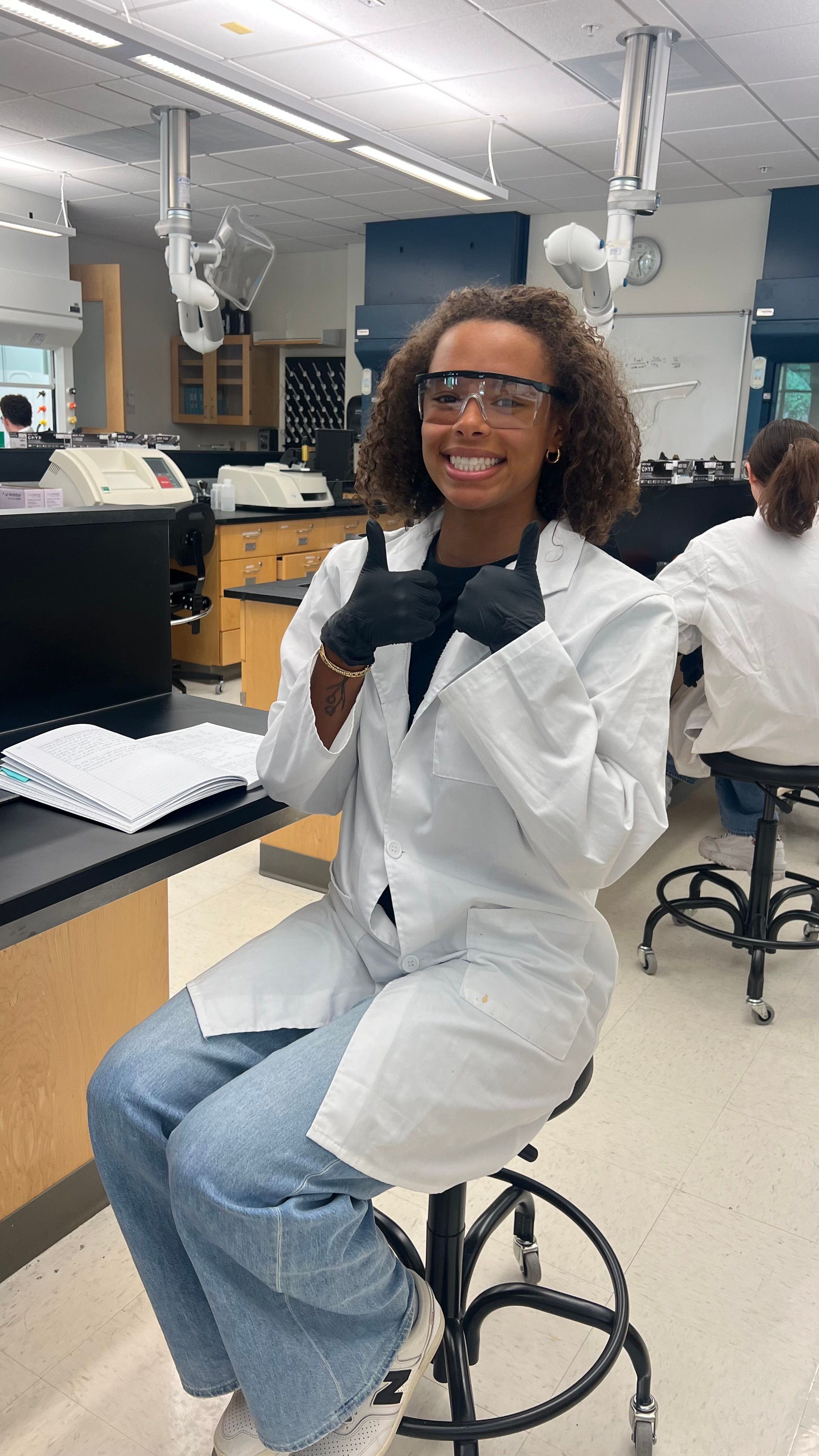 Rollins student poses in a lab.