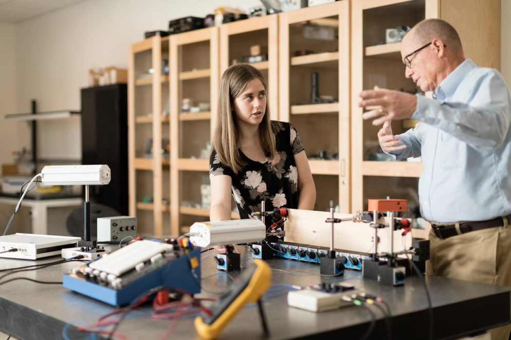 Lauren Neldner and professor Thom Moore in a classroom lab discussing a project.