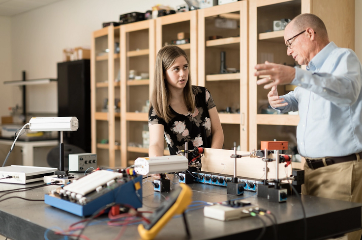 Lauren Neldner and professor Thom Moore in a classroom lab discussing a project.