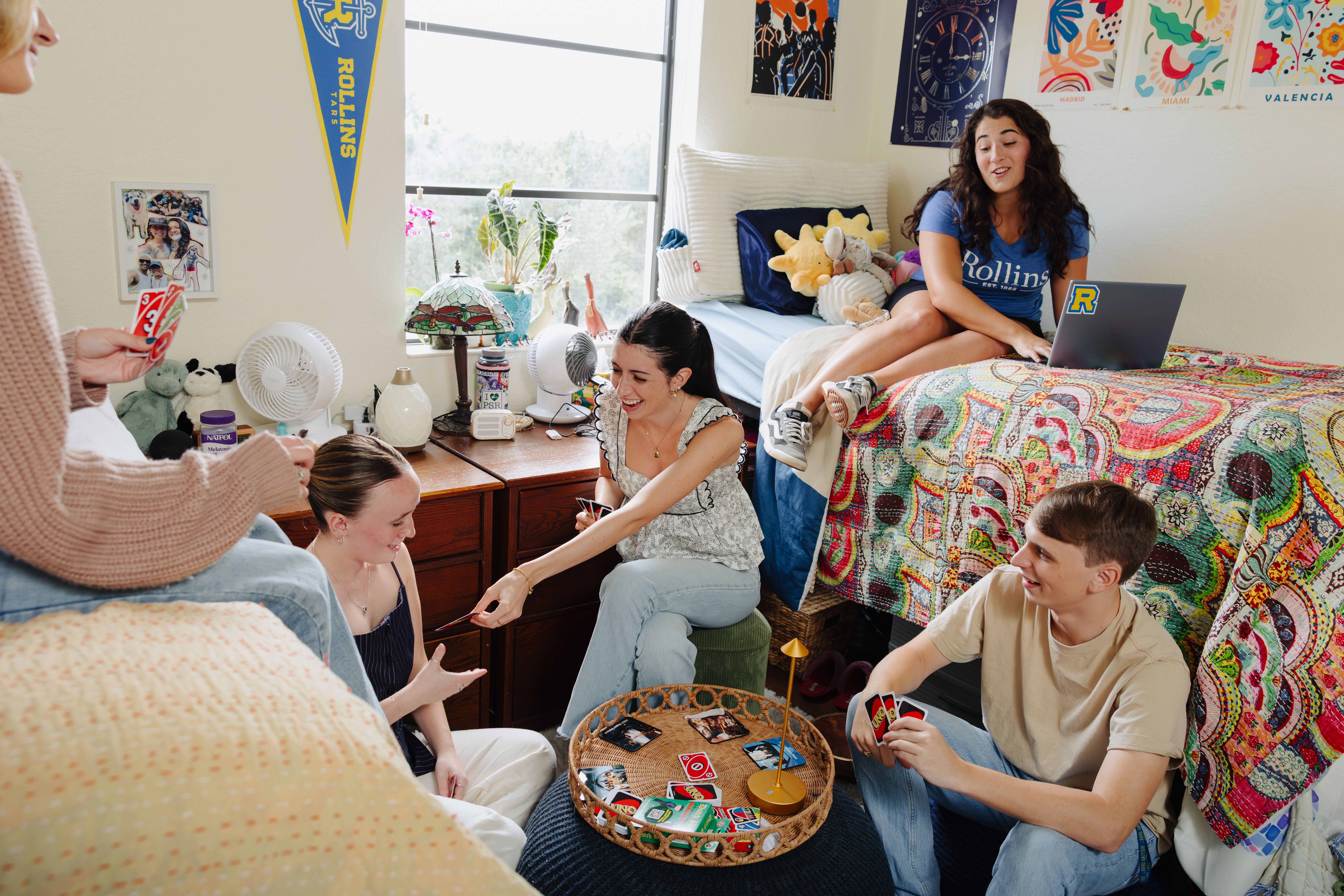 A group of students hanging out in their dorm room.