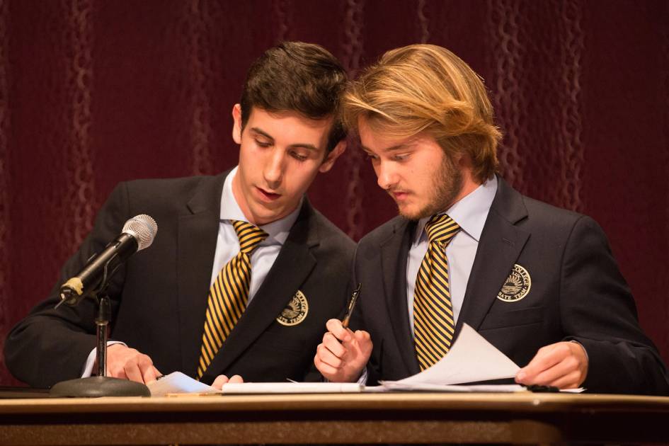 Two members of the Rollins Debate Team prepare for competition.