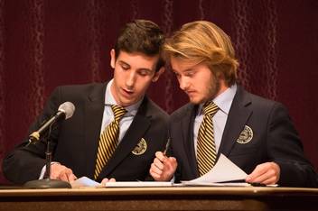 Two members of the Rollins Debate Team prepare for competition.