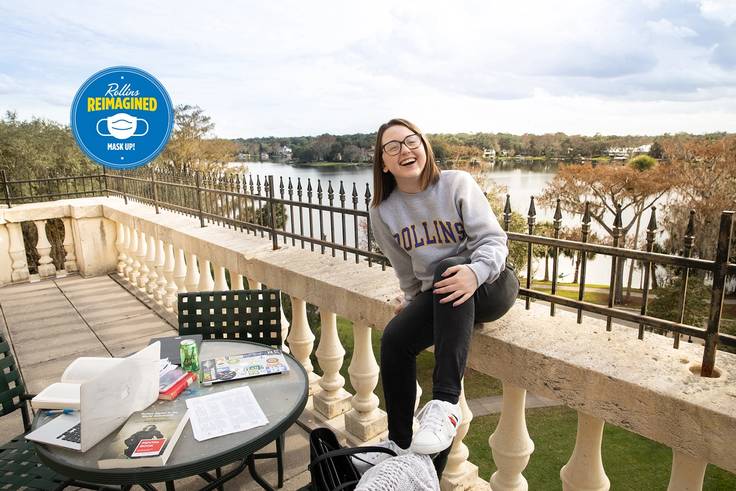 Sydney Brown ’20 studying on the balcony of her residence hall, Ward Hall, which overlooks Lake Virginia.
