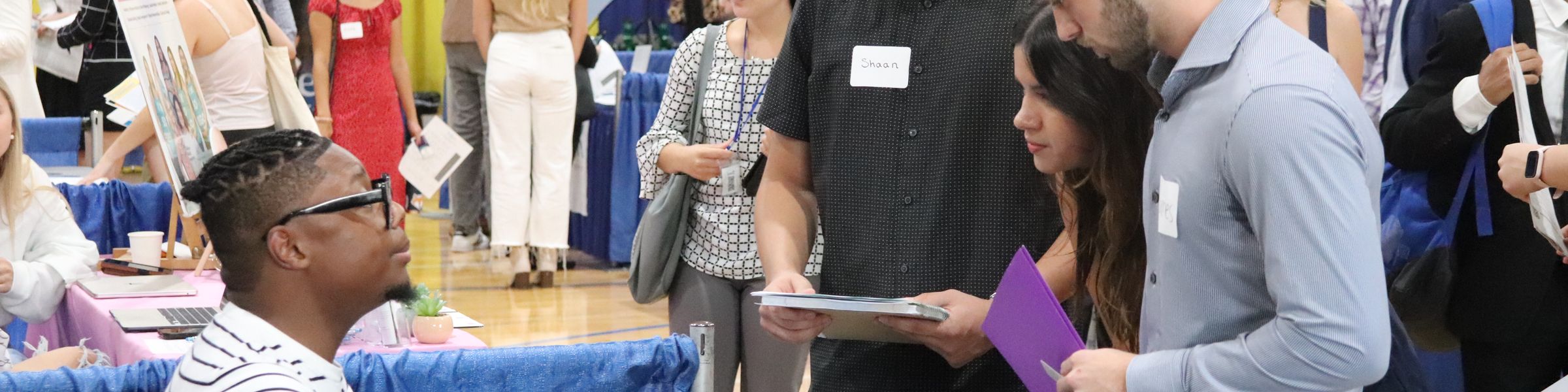 group of students talking to employer at job fair