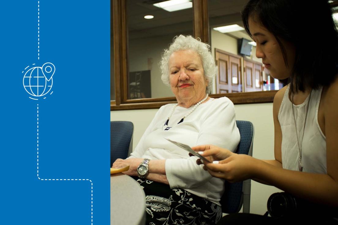 Renee Sang ’21 looks at pictures with an elderly resident of the nearby Mayflower community to examine the power of memory.