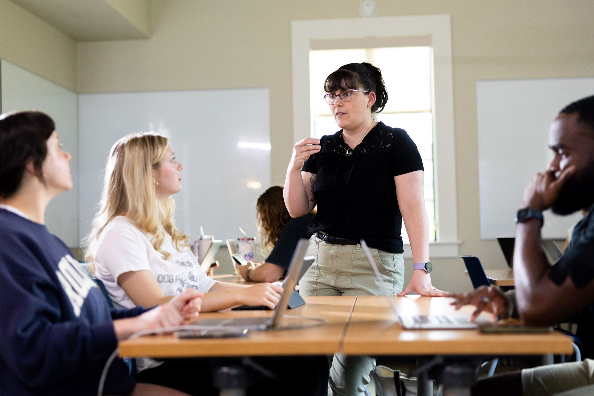 A professor works with a small group of students.