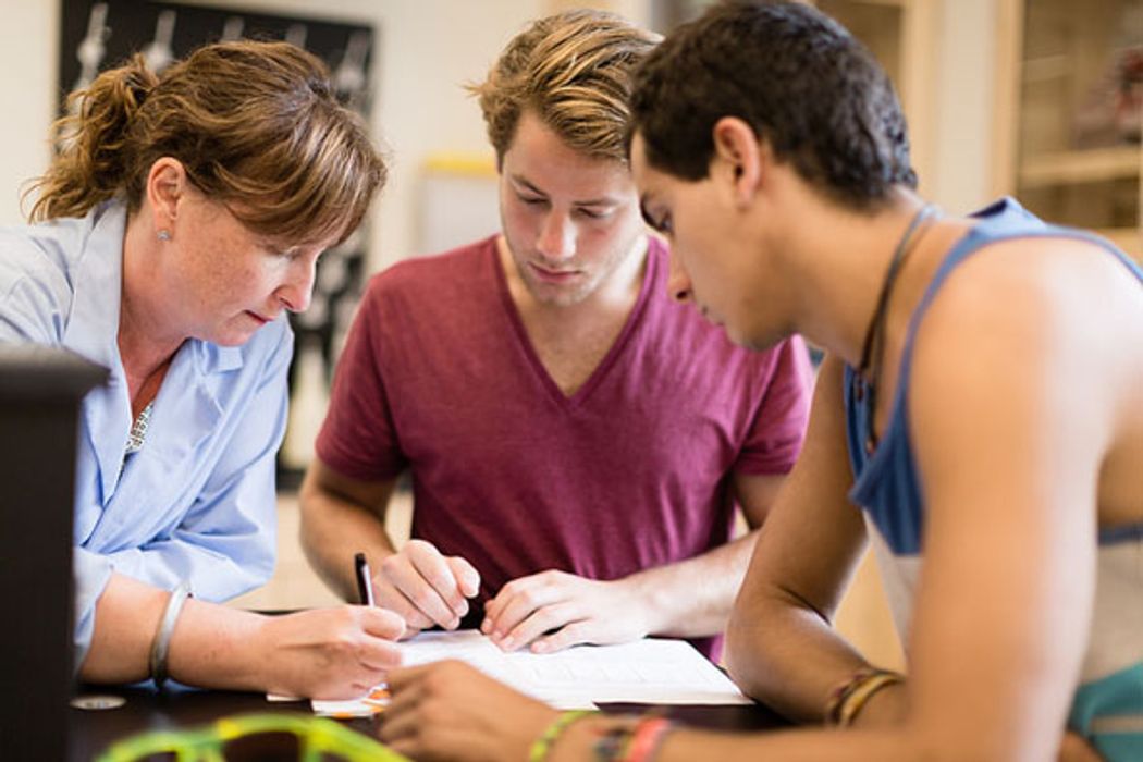 Rollins professor and students have an in-depth discussion at a table