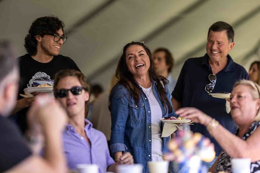 family laughing together on Rollins campus