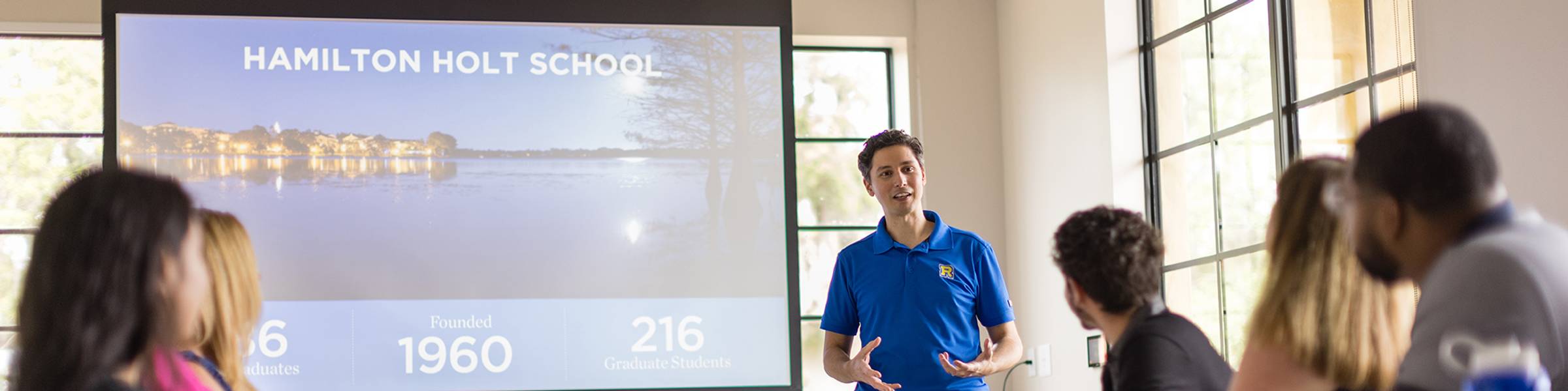 An admission counselor meets with a small group of prospective students.