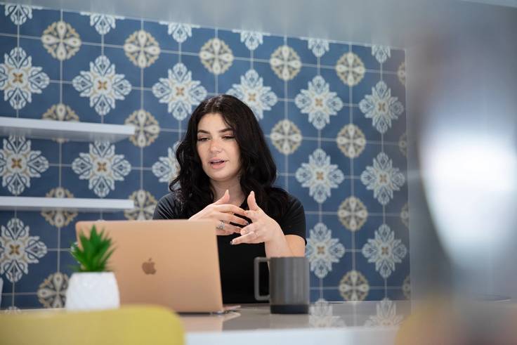 An admission counselor video chats with a student.