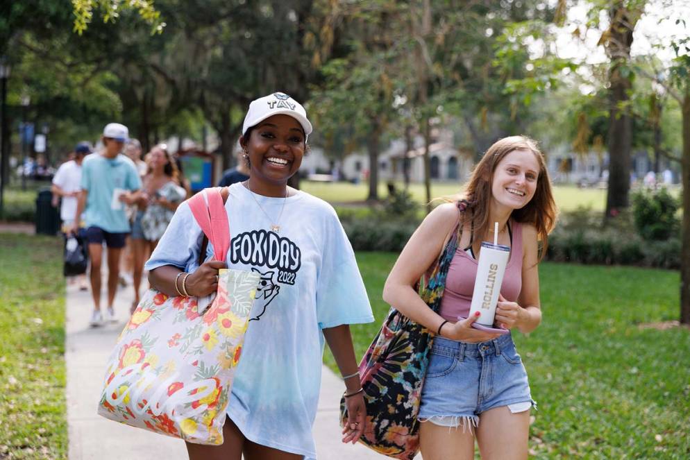 Two students in Rollins gear head to the annual Fox Day picnic.