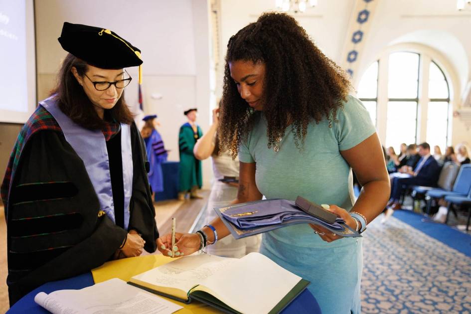 A new inductee to Rollins Phi Beta Kappa Society Chapter signs the logbook.