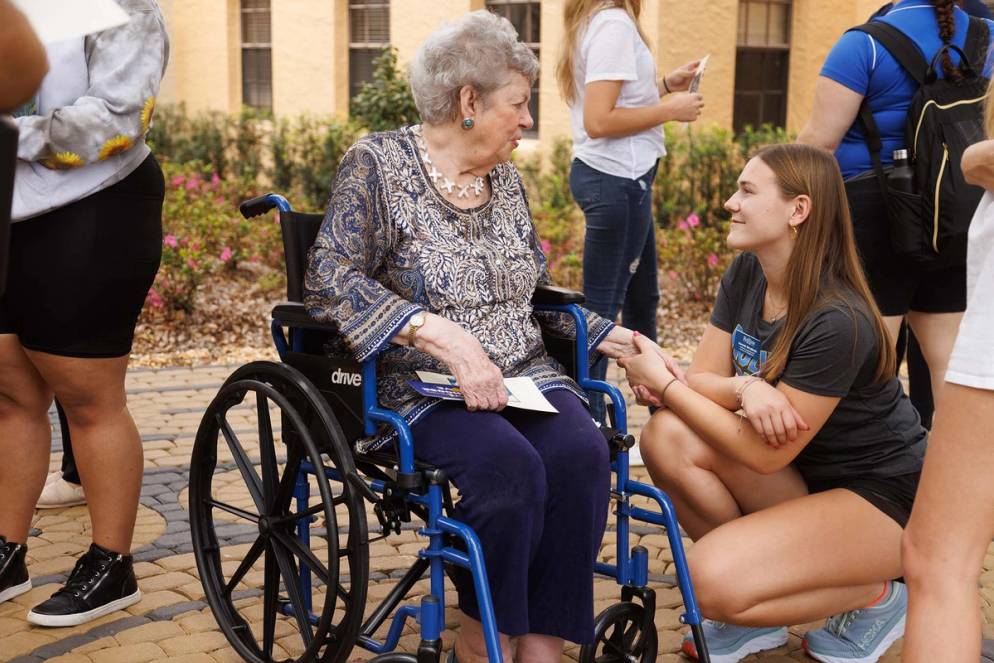 Thad's beloved wife, Polly, speaking with student Hannah Brodbeck ’25.