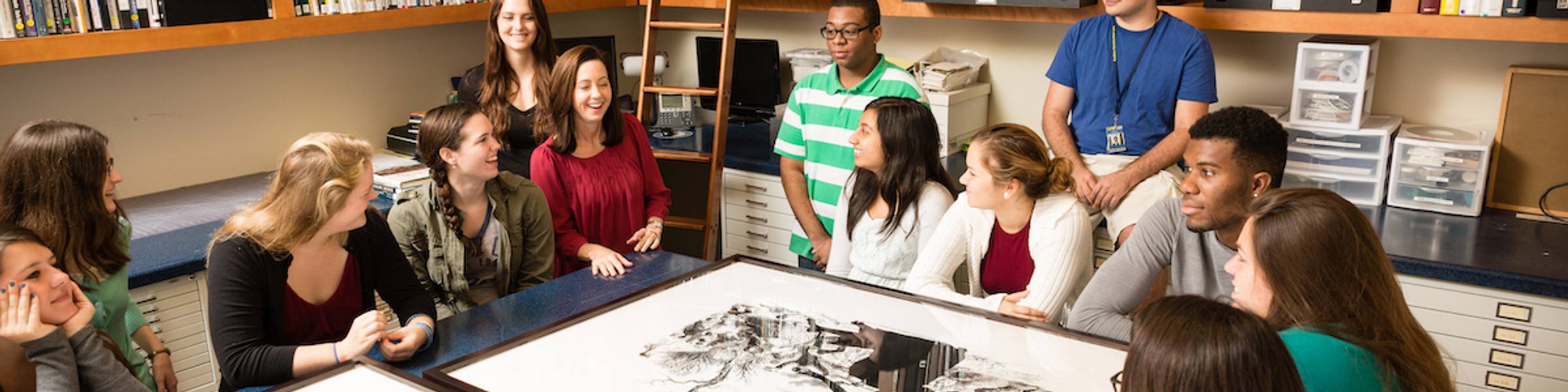A group of students look at art at Rollins College.