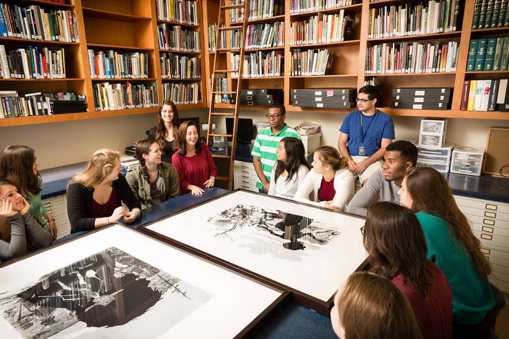 A group of students look at art at Rollins College.