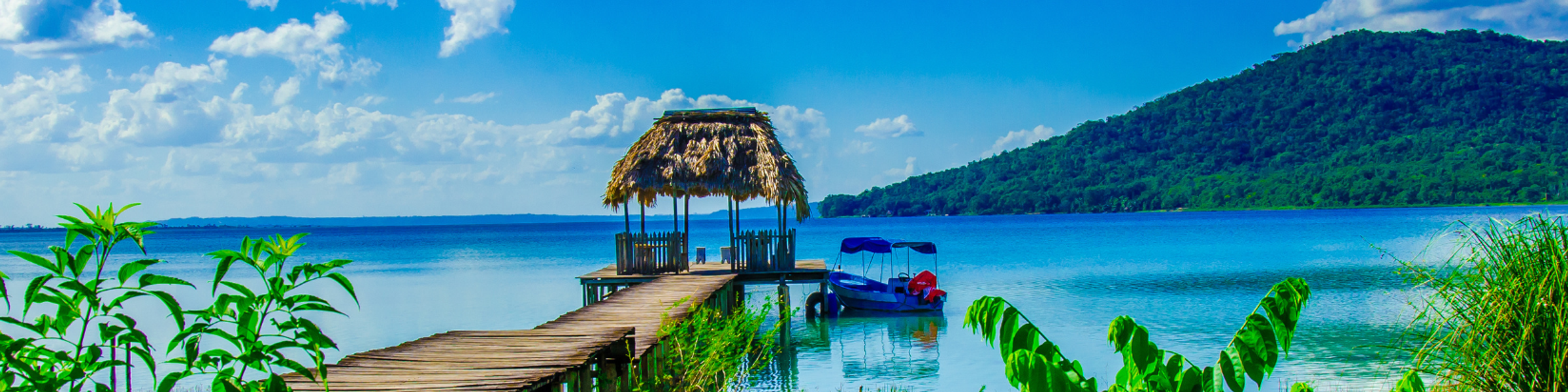 Image of a dock with a small boat in Belize.