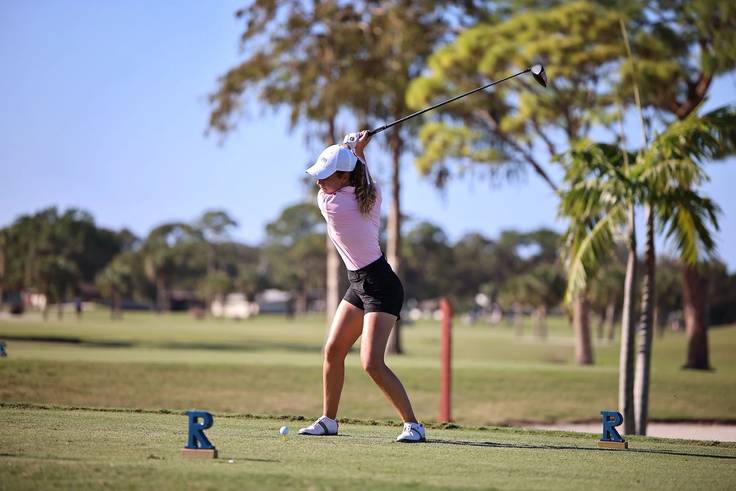 Olivia Tamburlini taking a golf swing during a tournament