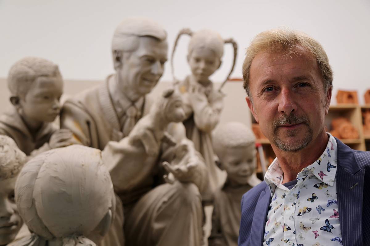 Artist Paul Day pictured with the Fred Rogers sculpture.