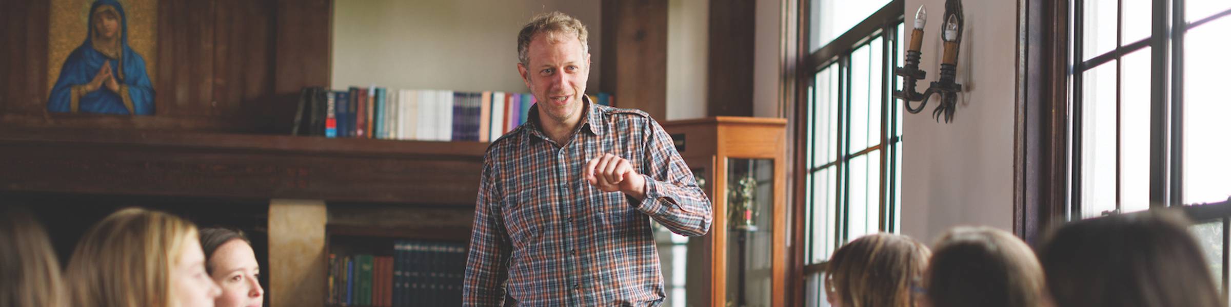 A professors leads a discussion with a small class of students.