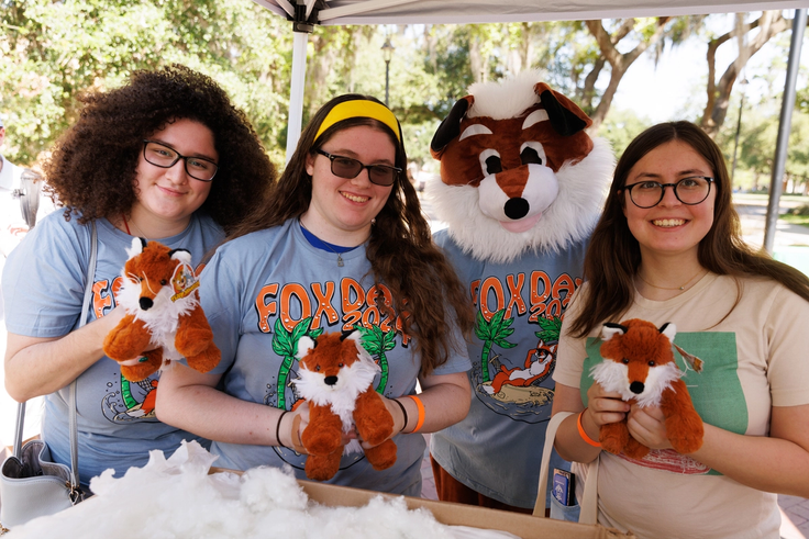 Students with the Fox mascot making fox plushies