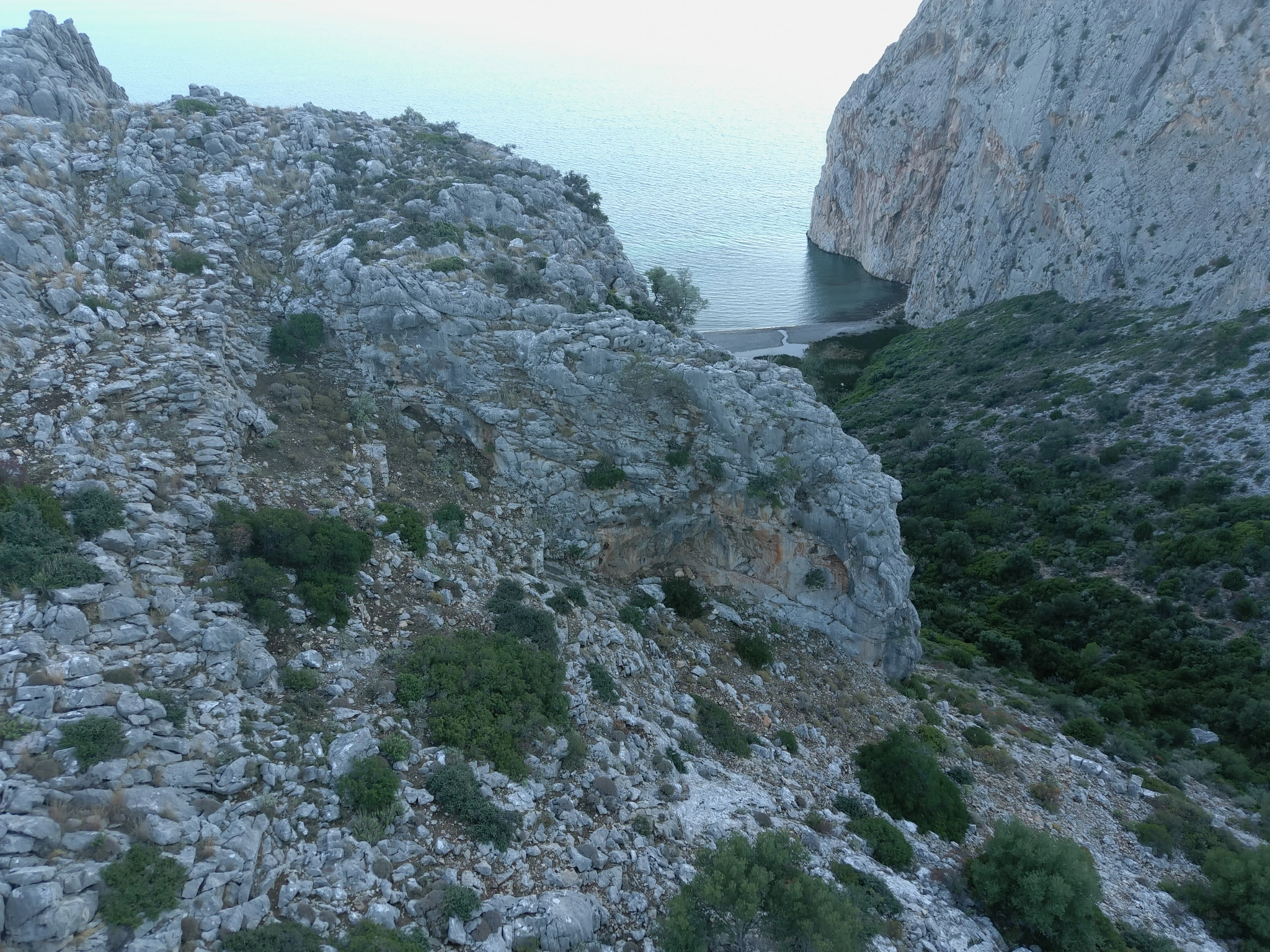 Figure 2 – Drone photograph of the site in front of the projecting bedrock from the north. Late-Final Neolithic occupation is observed on all three terraces (Photo: Frederik Vingaard © Project Pangali).