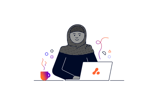 A person wearing a headscarf sitting in front of an Adaptavist Group laptop with a hot drink next to them