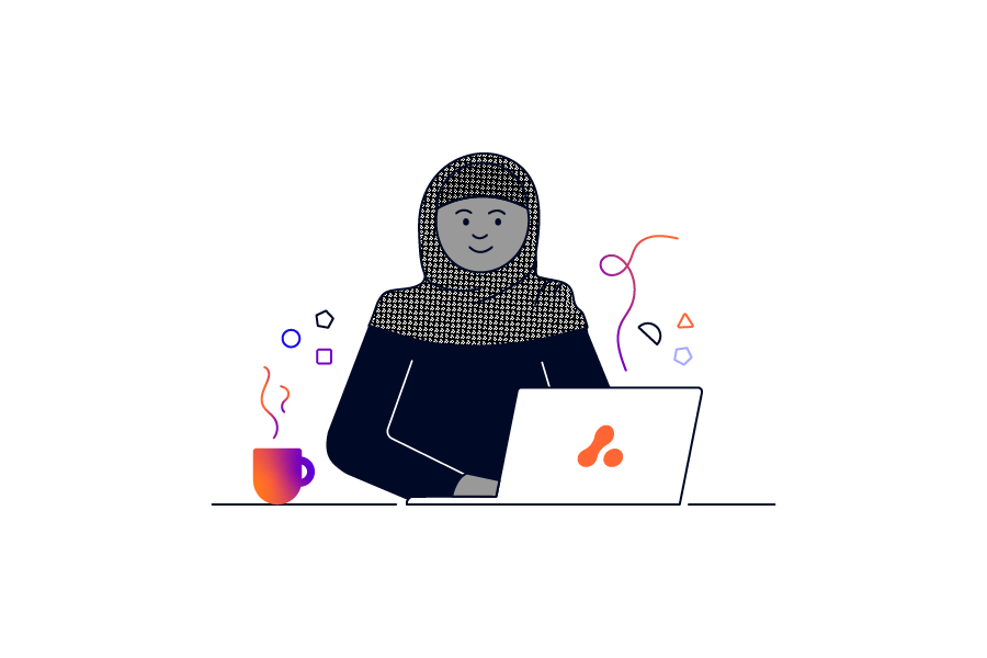 A person wearing a headscarf sitting in front of an Adaptavist Group laptop with a hot drink next to them